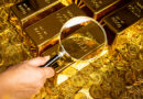 a-hand-with-a-magnifying-glass-checks-the-gold-bar