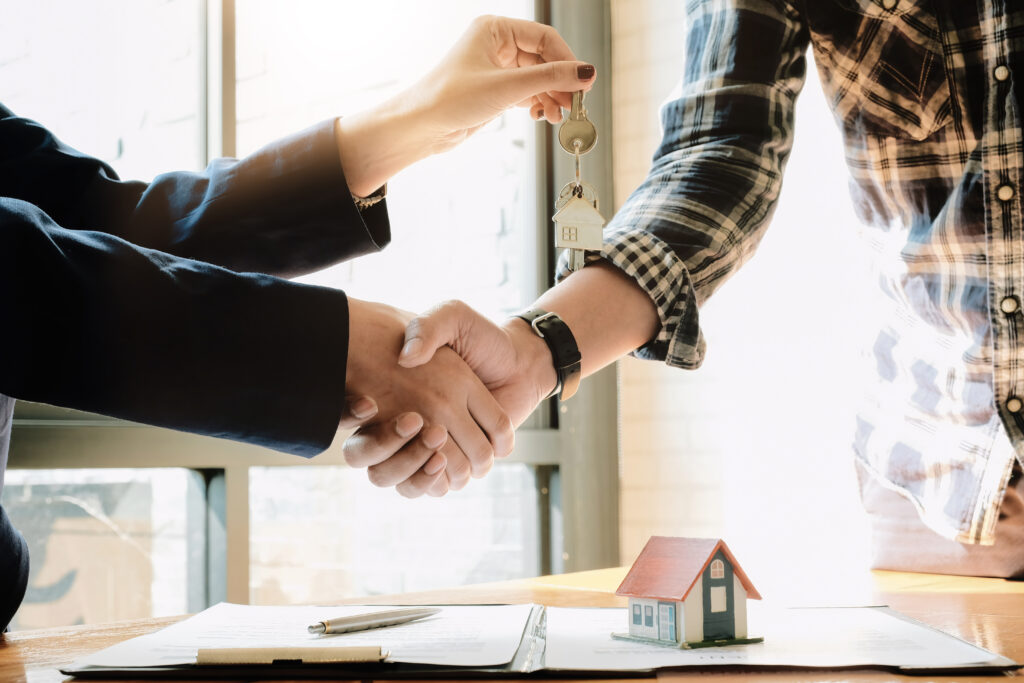 real-estate-agent-and-customers-shaking-hands